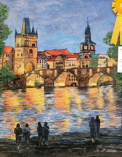 Quilt artwork showing Prague's Charles Bridge with towers and city skyline reflected in the river, people in foreground.