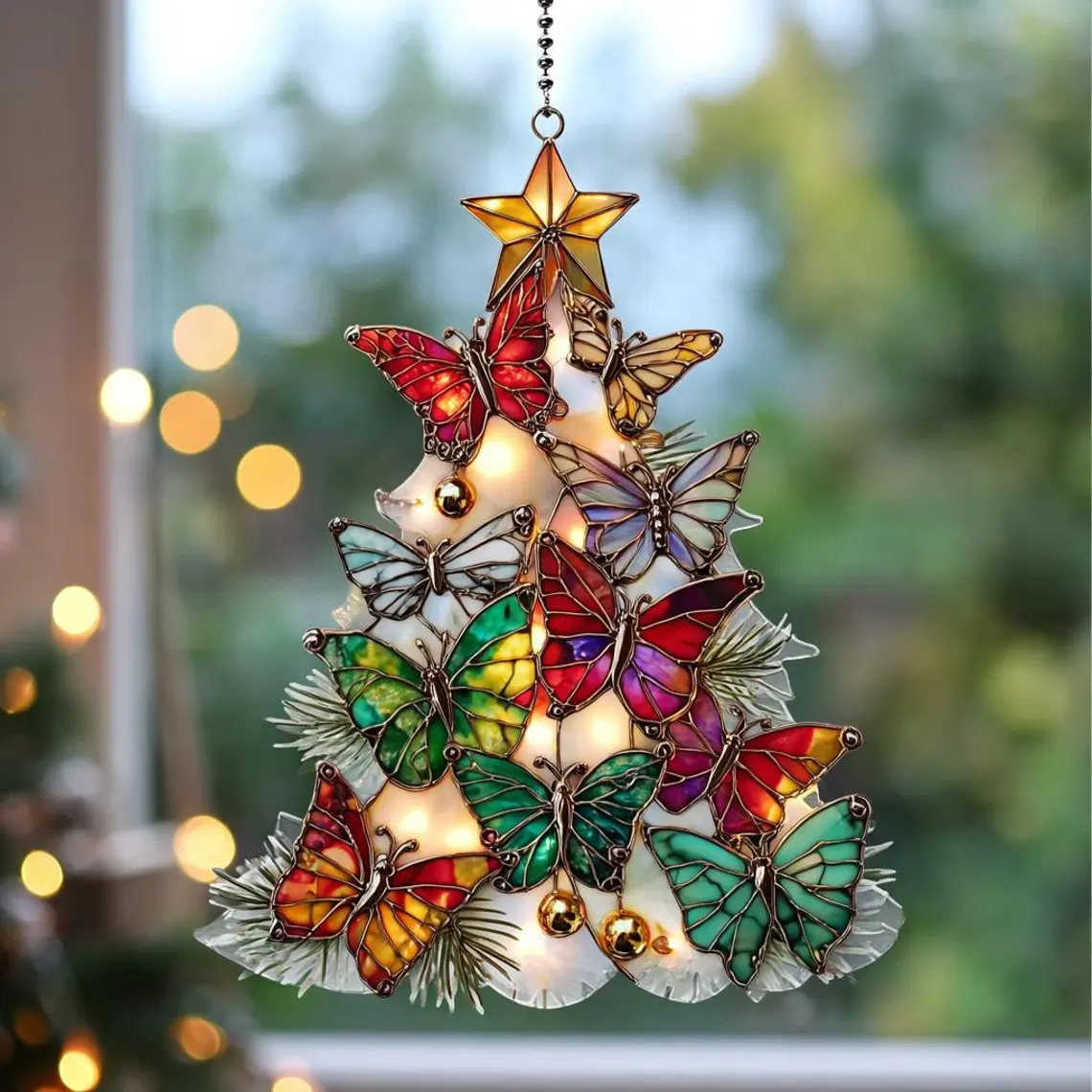 Colorful butterfly Christmas tree suncatcher hanging in a window
