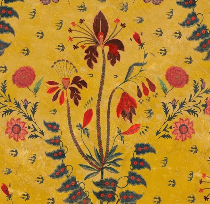Decorative floral fabric pattern with stylized flowers and leaves on a golden yellow background