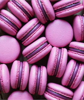 Close-up of several pink macarons arranged closely together