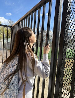 Woman Behind Chain Link Fence