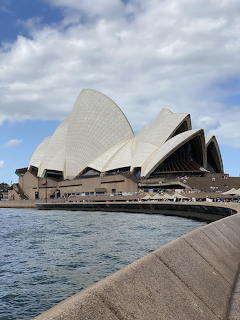 Sydney Opera House viewed from the harbour, showing its iconic white shell-shaped roof structures