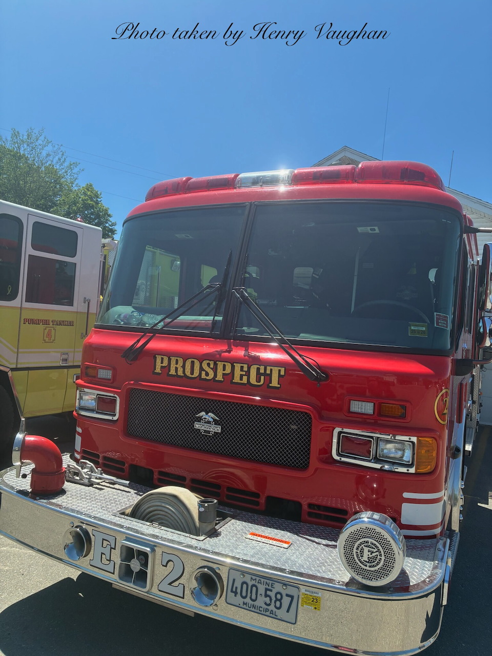 Front view of a red Prospect fire engine pumper truck parked outdoors