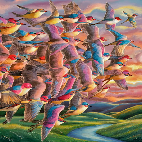 Flock of colorful birds flying together over green hills beneath a rainbow sunset sky