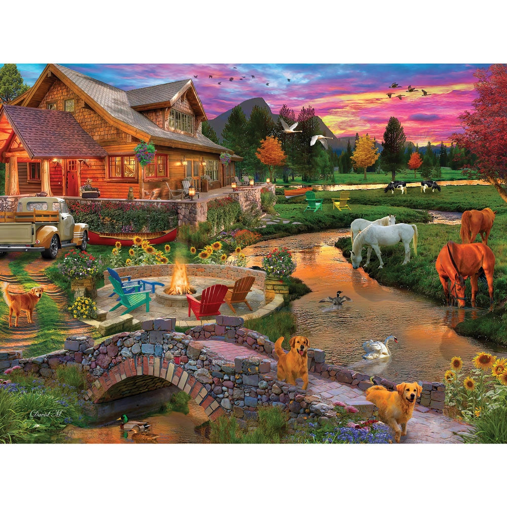 Idyllic farm at sunset with animals grazing by pond, barn and dramatic colorful sky