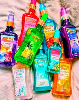 Assorted colorful Hawaiian Tropic bottles displayed on sandy beach background