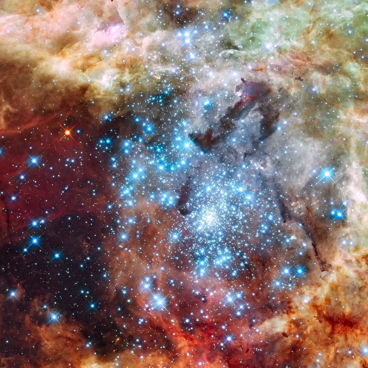 Colorful deep space image of Tarantula Nebula with glowing gas clouds and bright stars in orange, blue and red tones