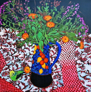 Painting of wildflowers in a blue vase on a patterned tablecloth with oranges and a green bird
