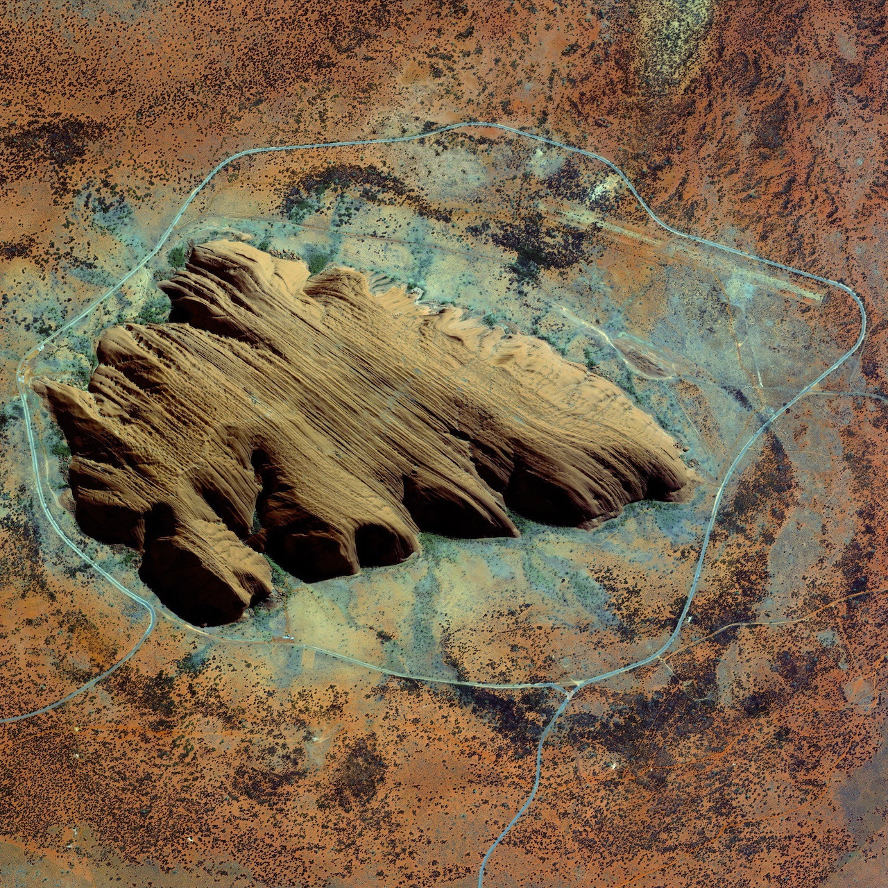 Aerial view of Uluru (Ayers Rock) sandstone monolith in the Australian outback desert