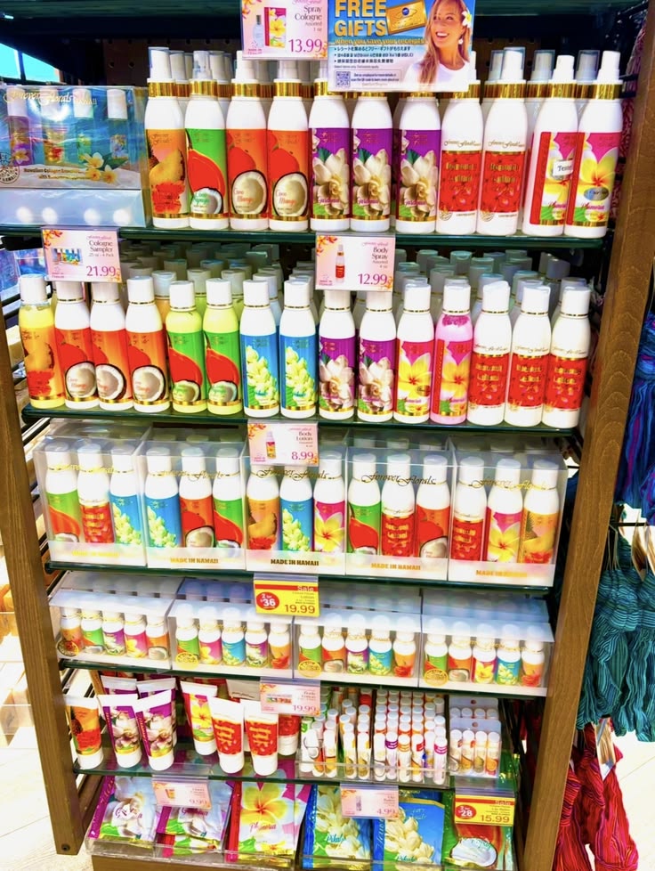 Retail shelves stocked with colorful tropical scented lotion and spray bottles in a Hawaii ABC store
