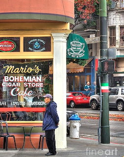 Corner storefront of Mario's Bohemian Cigar Store with yellow awning, green street pole, and red car parked on urban street