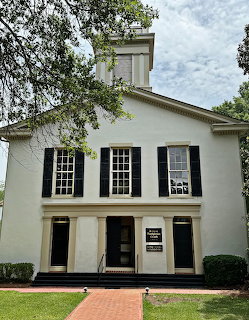 Historic white church with black shutters and columns in Madison, Georgia