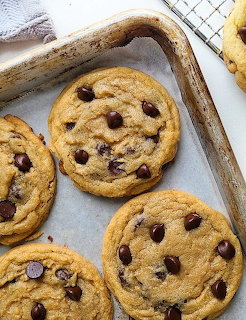 Close-up of chocolate chip cookies on a parchment-lined baking tray