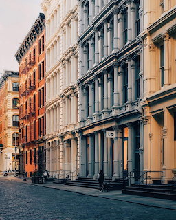 Row of historic cast-iron buildings with ornate facades in Soho, New York City