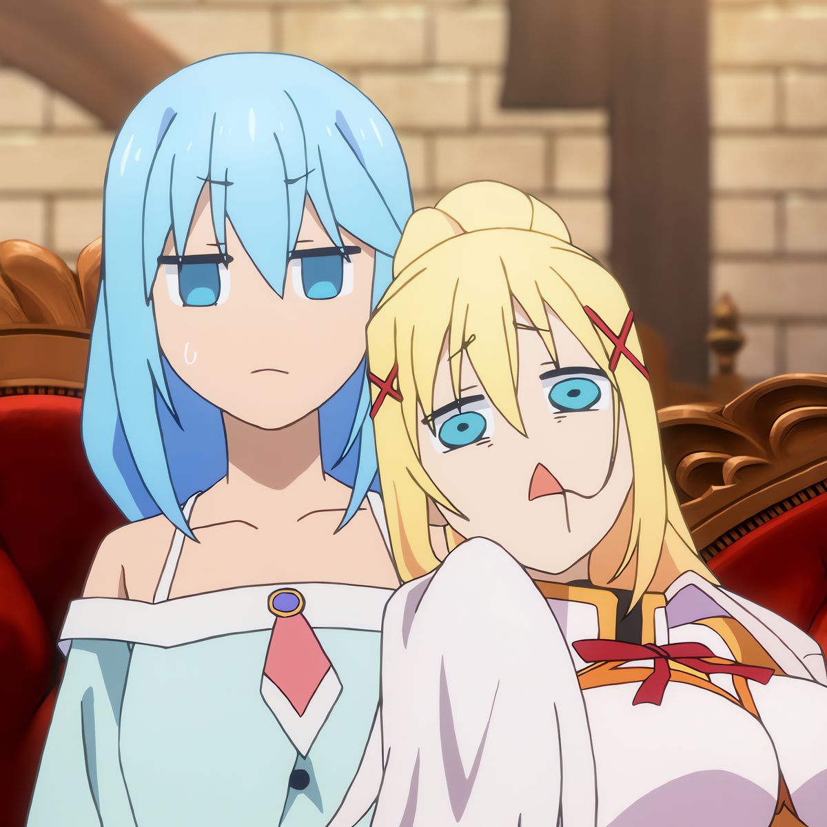 Two anime girls, one with blue hair and one with blonde hair, sitting on a red velvet throne