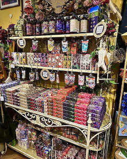 Shop display shelf stocked with colorful soaps, lotions, and bath products in decorative packaging