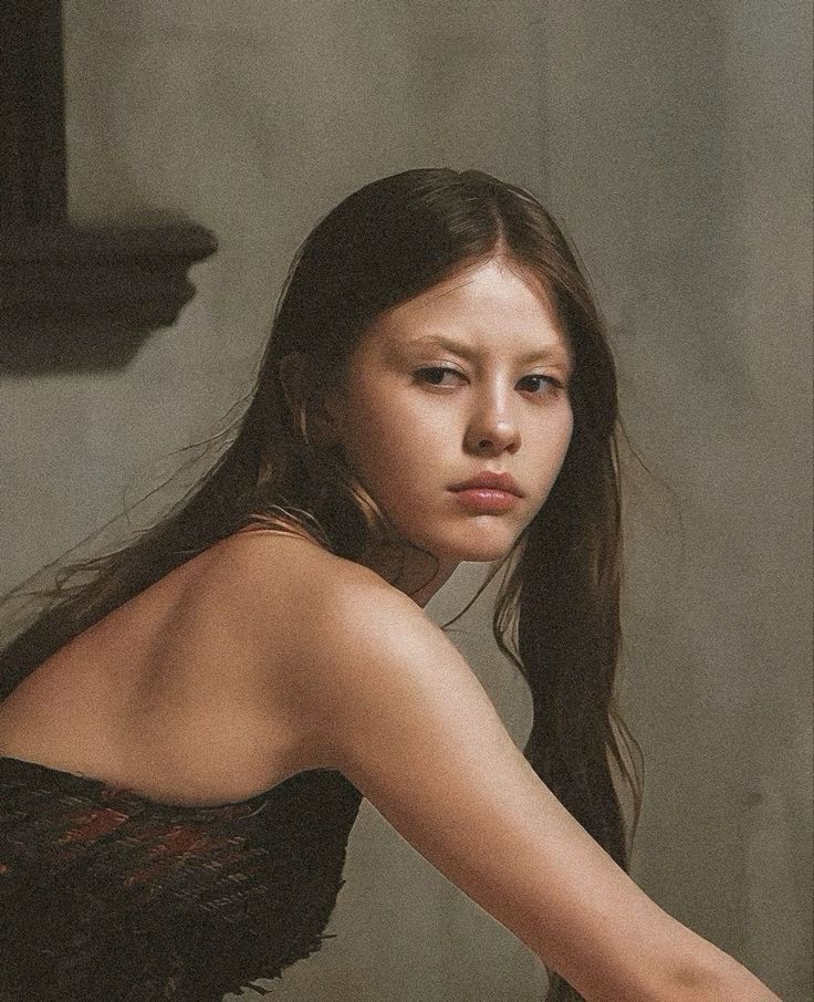 Close-up portrait of Mia Goth with light brown hair and neutral makeup