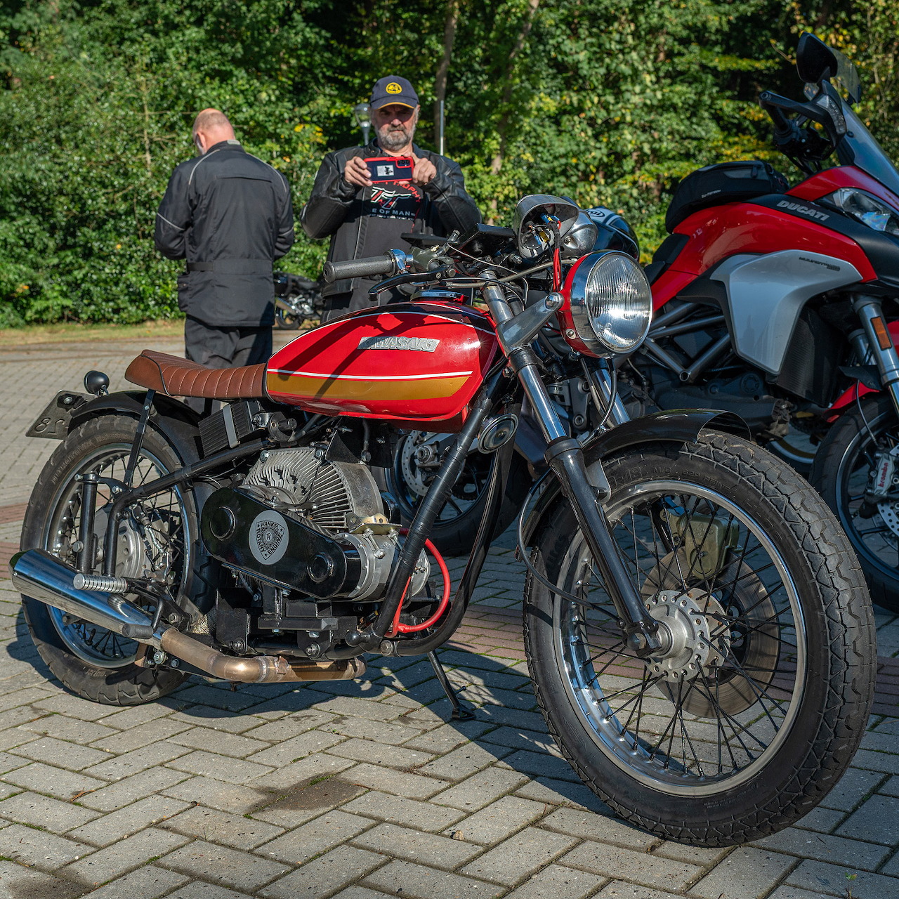 Custom red Kawasaki KZ400 motorcycle with Wankel engine parked outdoors
