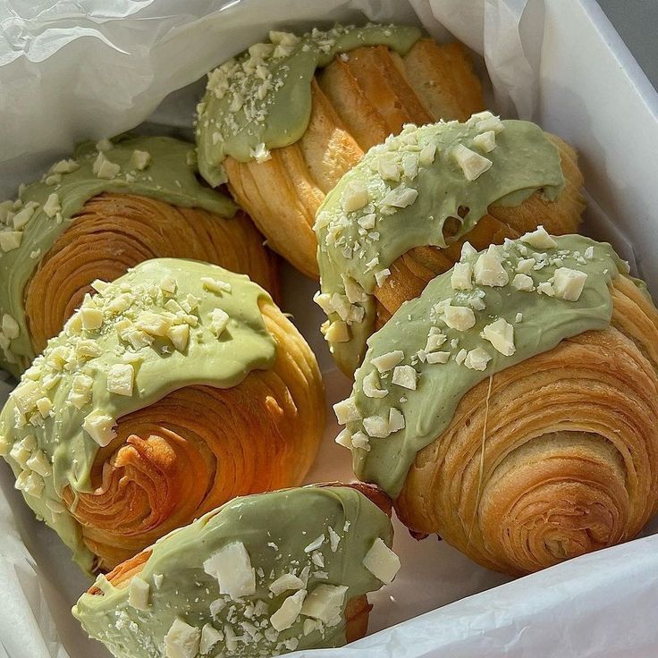 Croissants with pistachio topping and white chocolate in a box