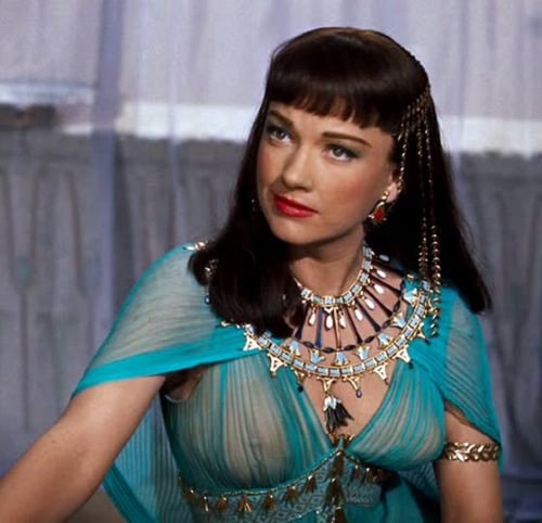 Anne Baxter wearing a turquoise Egyptian-style costume and ornate jewelry in a portrait