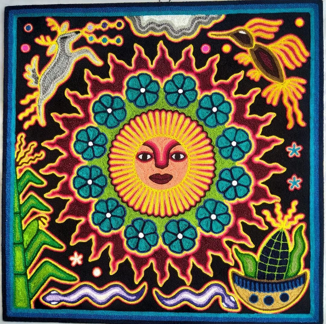 Colorful Huichol folk art with central sun face, turquoise flowers, and symbolic animals in traditional yarn painting style