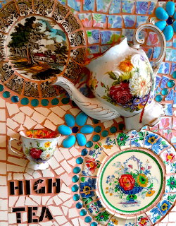 Ornate floral teapot and decorative plates on colorful mosaic tile surface