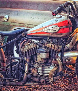 Vintage Harley-Davidson motorcycle with exposed V-twin engine and red fuel tank