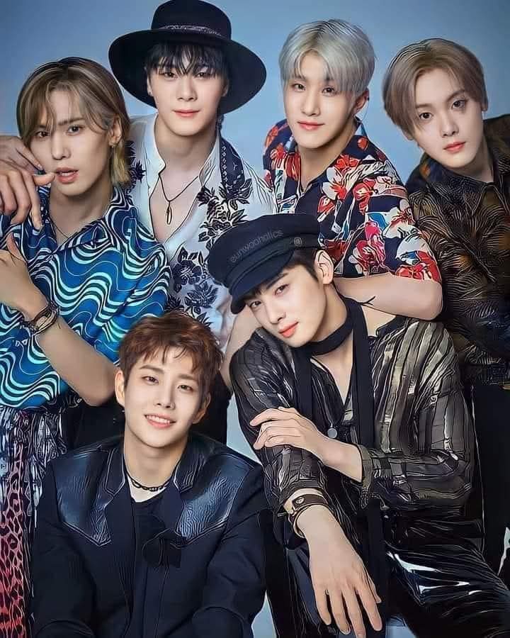 Six members of K-pop group ASTRO posing together in colorful stylish outfits