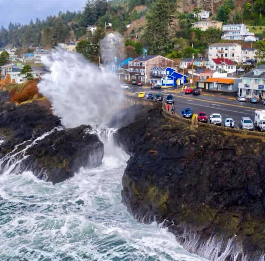 Large waves crashing against rocky cliffs beside the seaside town of Depoe Bay