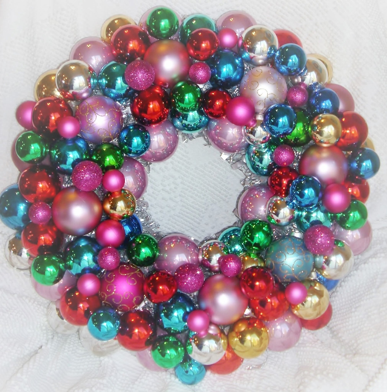Wreath made of colorful shiny Christmas ornament balls in various metallic and bright colors
