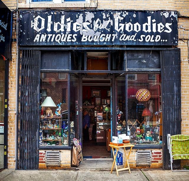 Oldies but Goodies antique store exterior with vintage items displayed in windows and entrance