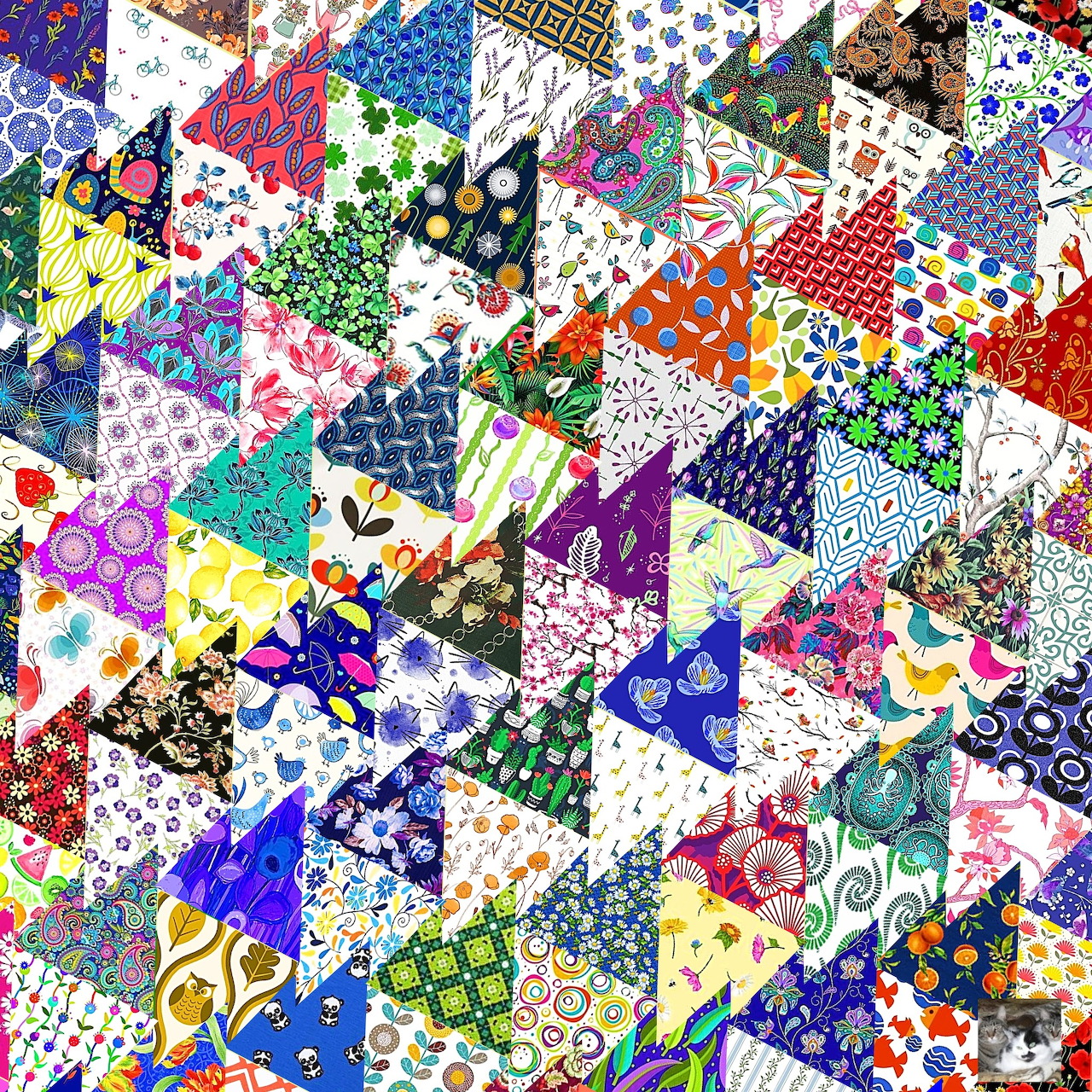 Colorful patchwork quilt with triangular fabric pieces in diverse patterns and colors arranged in a complex geometric design