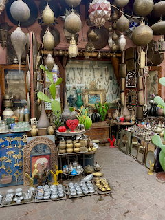 Morocan shop in Marrakech with hanging metal lanterns, pottery, ceramics, and colorful decorative goods