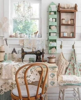 Vintage sewing room with antique sewing machine, chair, shelves, lace fabric, and a window