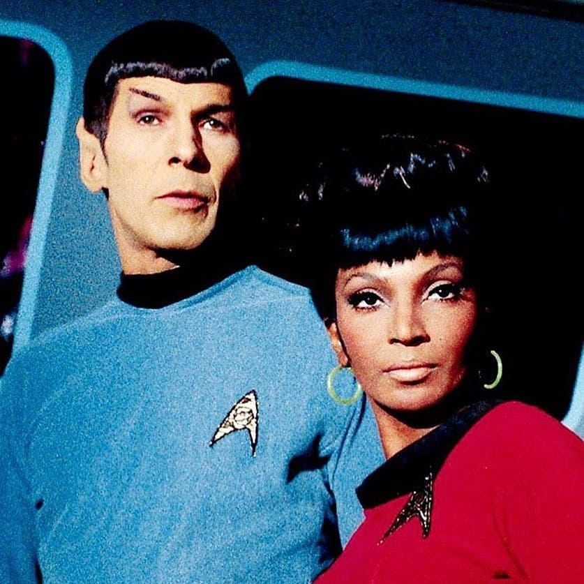 Spock and Uhura from Star Trek in uniform against starfield