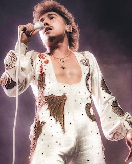 Singer Josh Kiszka performing live on stage with microphone
