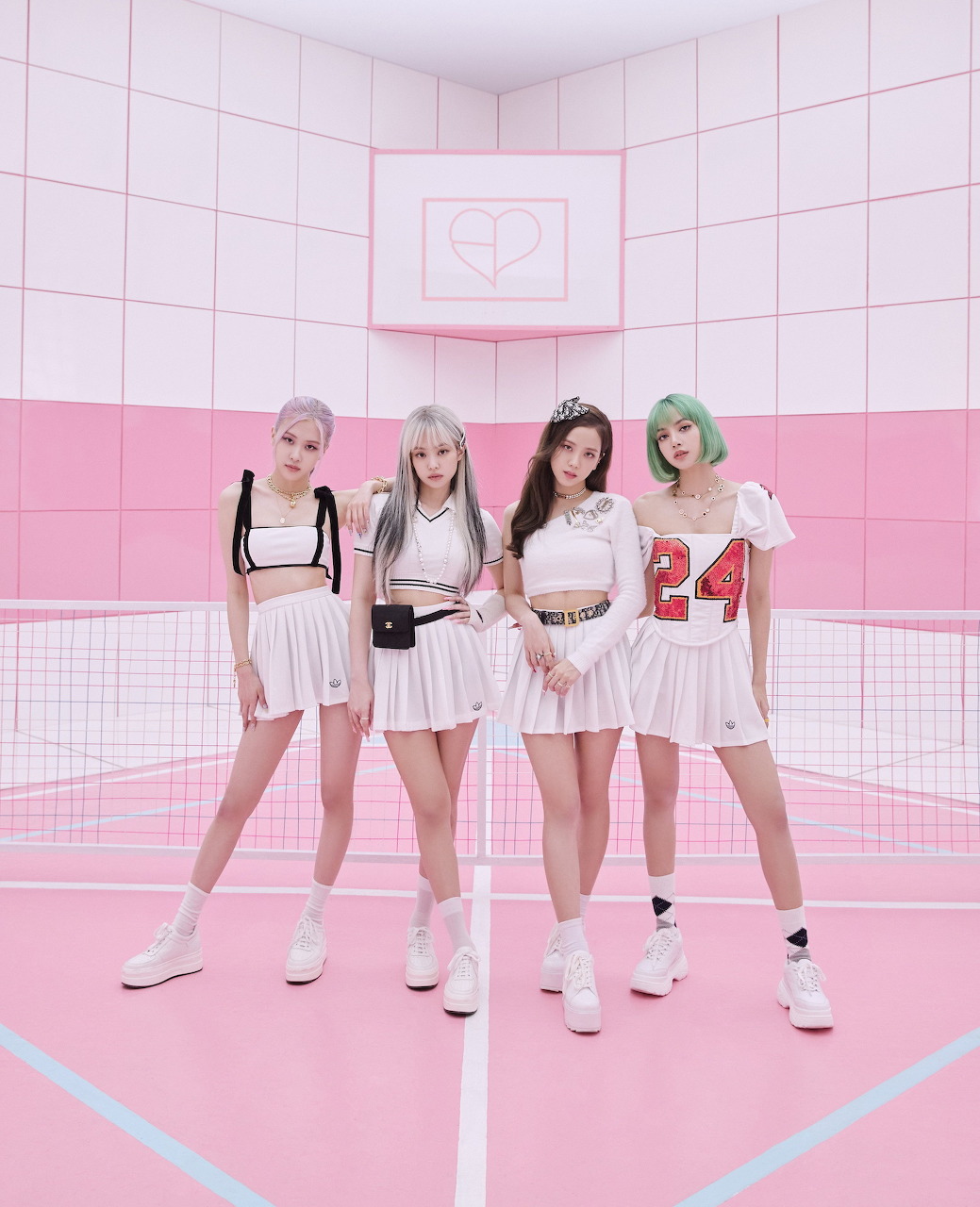 Four K-pop women in white outfits posing on a pink indoor court