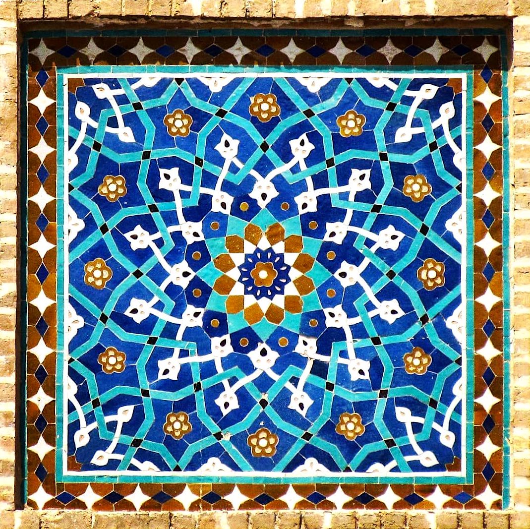 Symmetrical Persian geometric mosaic with blue and white Islamic patterns and ornate border