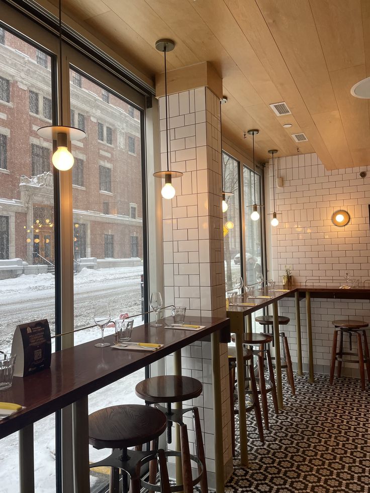 Illustration of a cafe window with candles, honey, and coffee on a snowy night