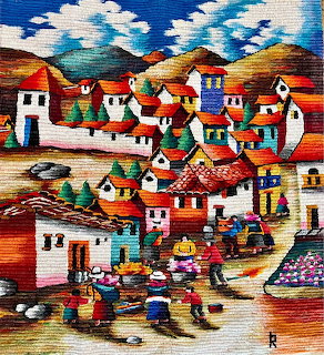Colorful woven tapestry of an Andean village with houses, mountains, and villagers in traditional dress