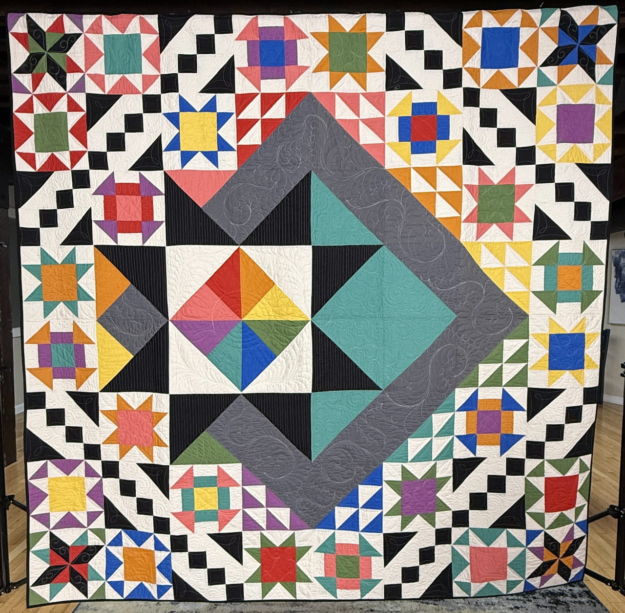 Colorful geometric quilt with diamond center and mixed patchwork blocks