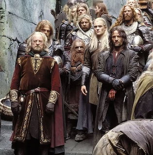 Group of fantasy characters in robes and armor standing in a stone courtyard