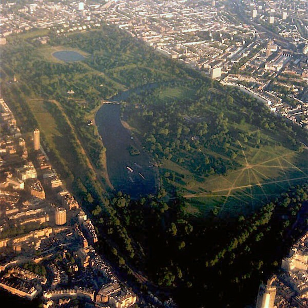 Aerial photograph of Hyde Park, London, with the Serpentine lake surrounded by trees and buildings