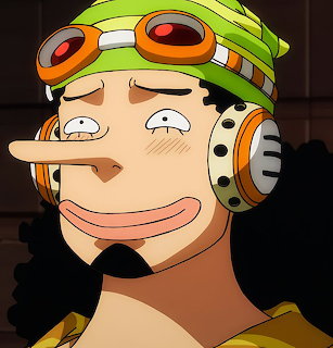 Close-up anime portrait of Usopp with orange goggles, headphones, and a long nose