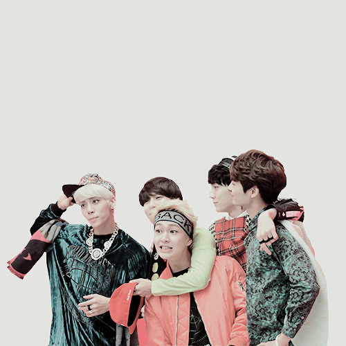 Five SHINee members posing together in colorful clothes on a white background
