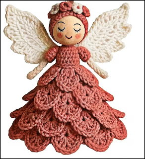 Crocheted angel doll with white wings and layered pink ombre dress on white background