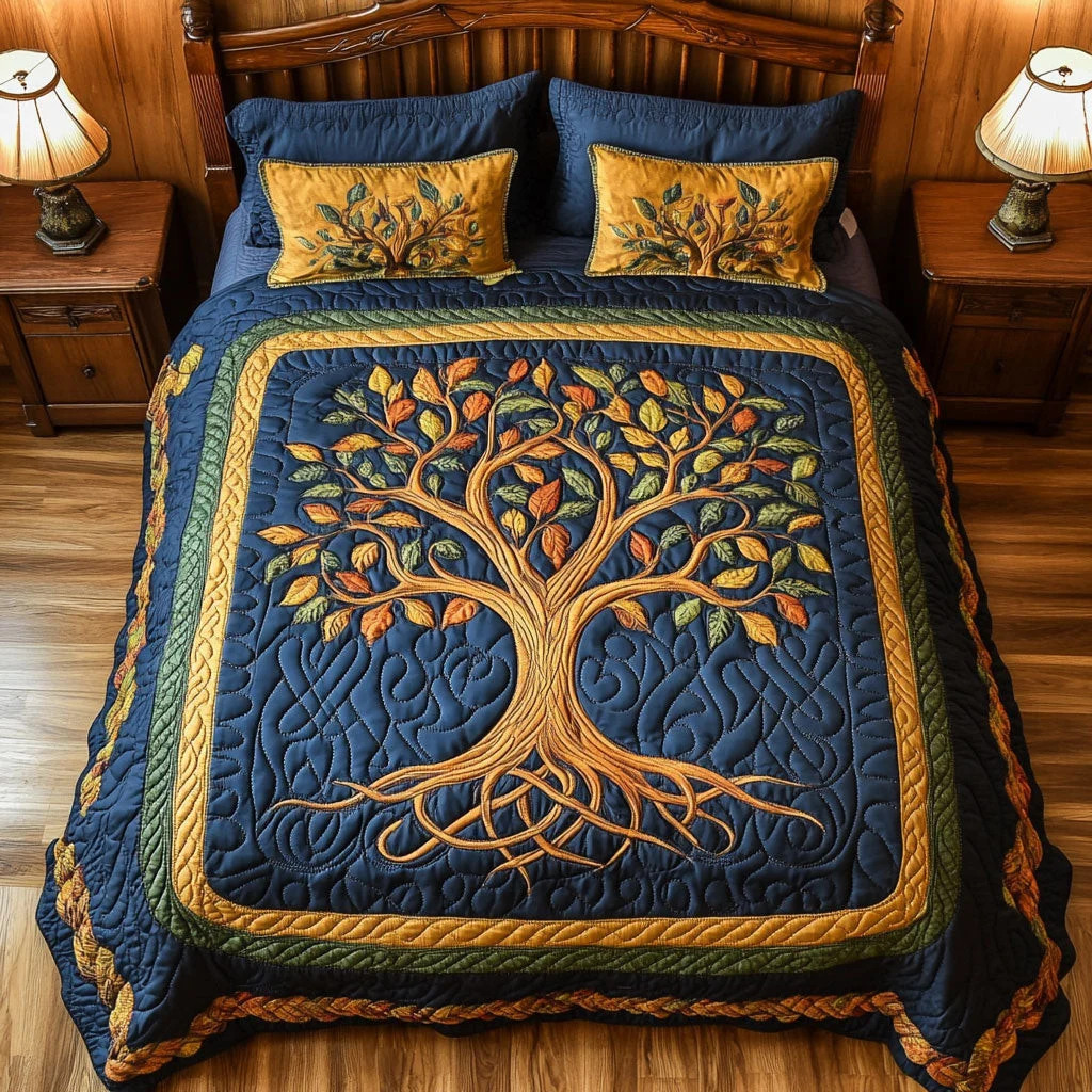 Blue quilt on a bed featuring a golden tree of life pattern, with matching pillows and bedside lamps