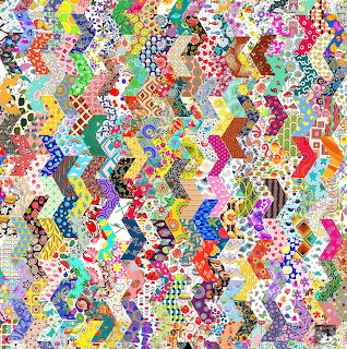 Colorful chevron patchwork quilt with diverse fabric patterns in zigzag arrangement