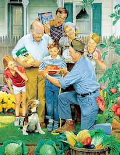 Multigenerational family sitting together reading a book outdoors with dog and garden