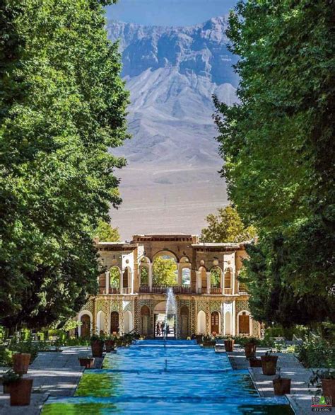 Shazdeh Garden in Mahan, Iran with central water canal, trees, and mountains
